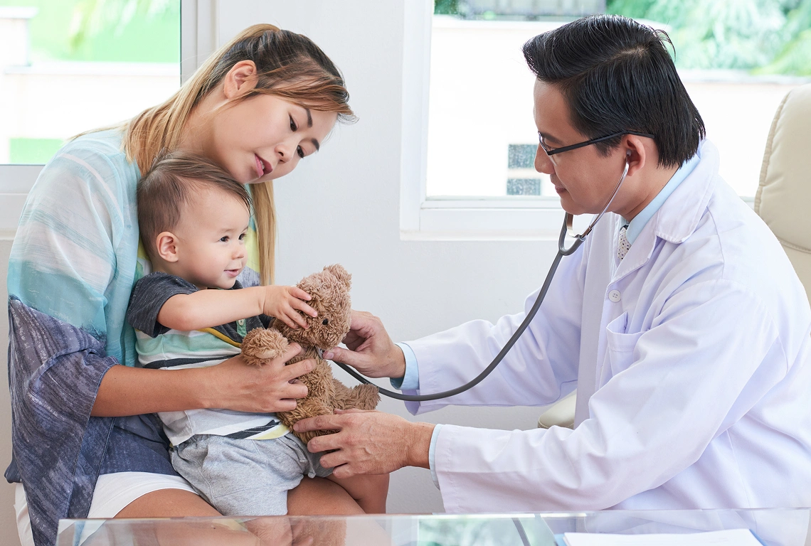 Doctor caring for child with parent